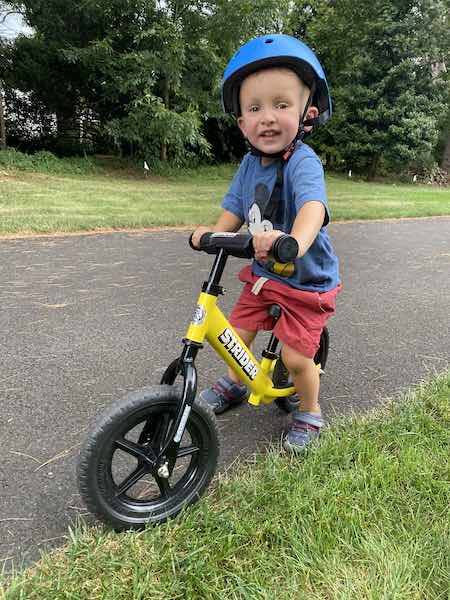 my son riding his balance bike for perfect 2 year old bike