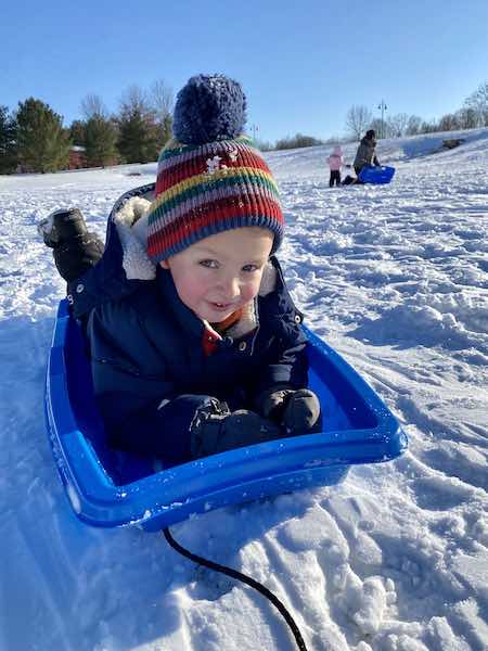 best outdoor activities for toddlers sledding down a hill