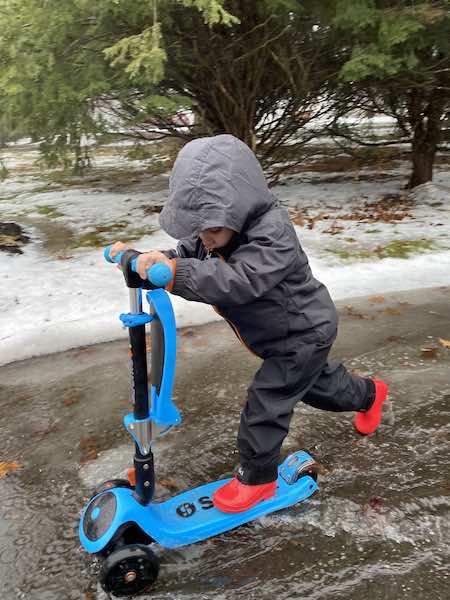 outdoor rainy day activities: toddler riding scooter