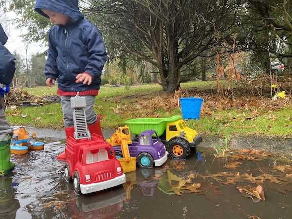 toddler outdoor rainy day activities: trucks and puddles