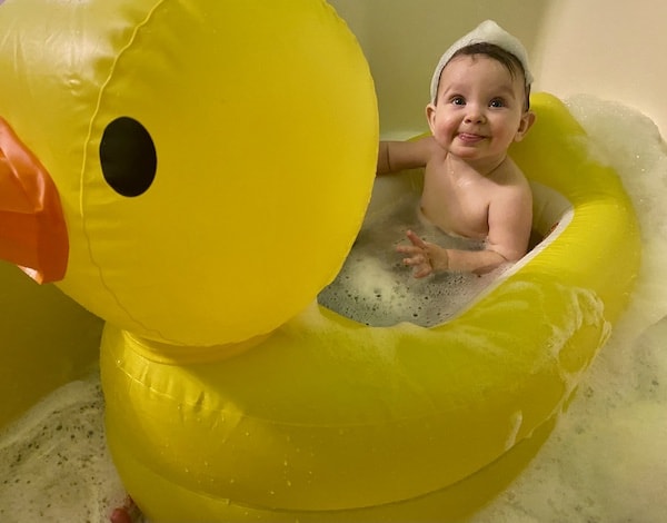 my daughter in our travel baby bathtub