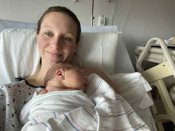 Postpartum in hospital gown after giving birth