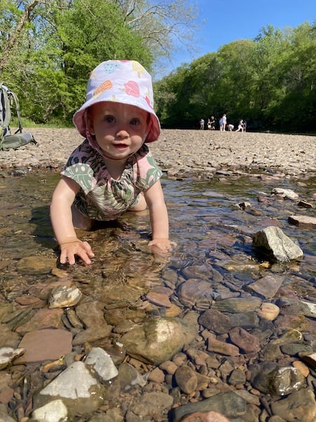 outdoor adventure with baby exploring water and rocks