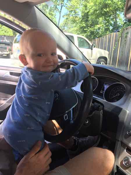 baby driving on road trip with baby