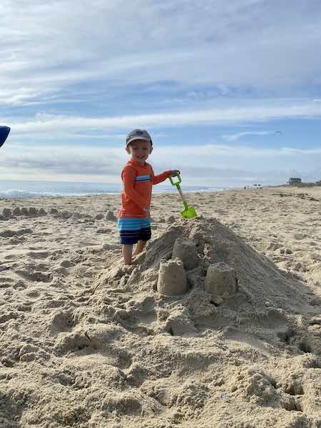 toddler beach essentials way to have fun: sandcastles