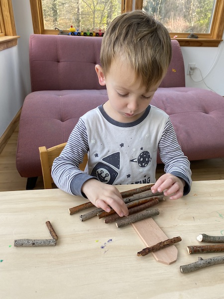 my 3 year old designing his nature Christmas tree