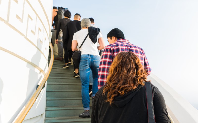 Line of people walking up steps