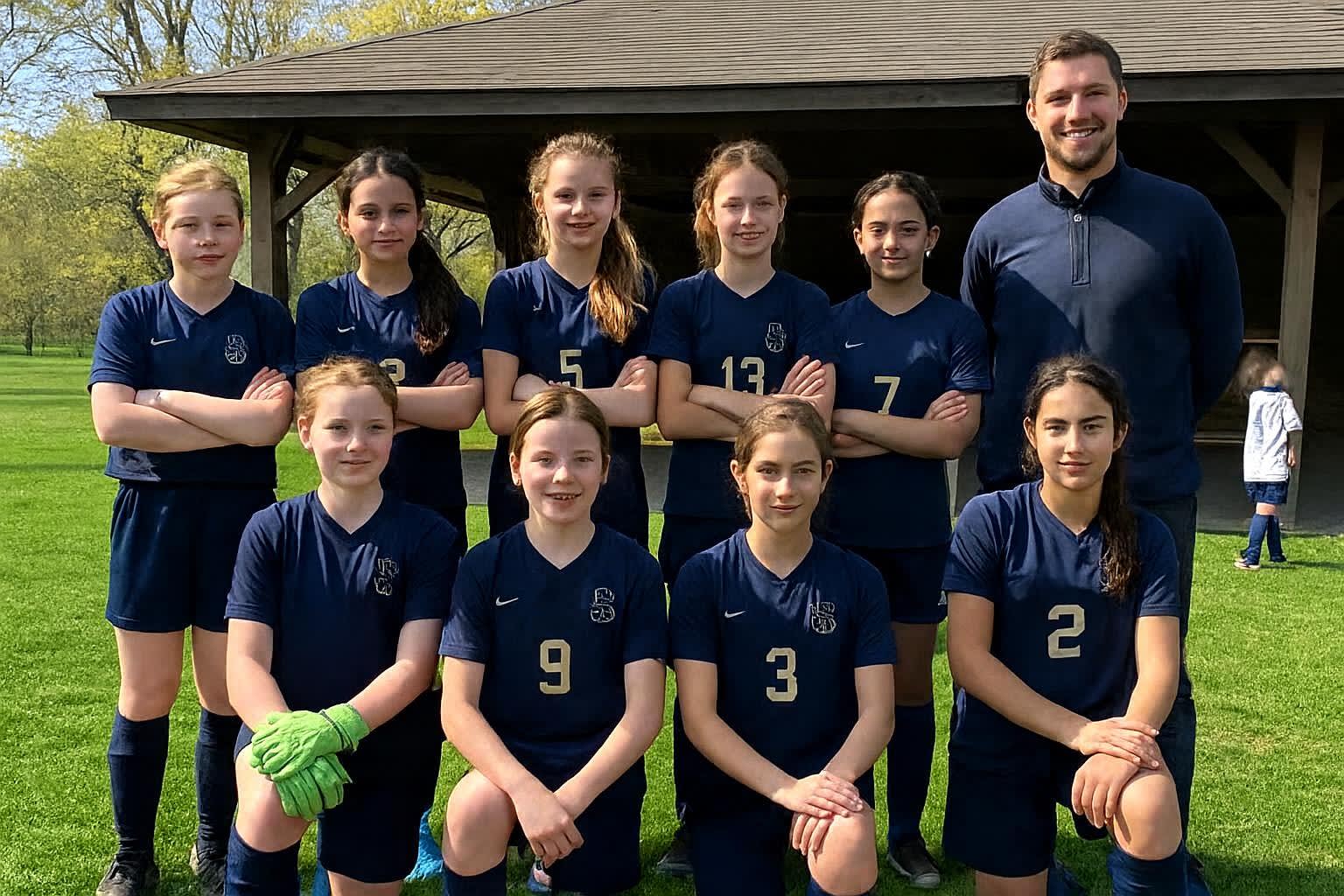 U12 Girls, spring picture day. Ella in the gloves, front row.
