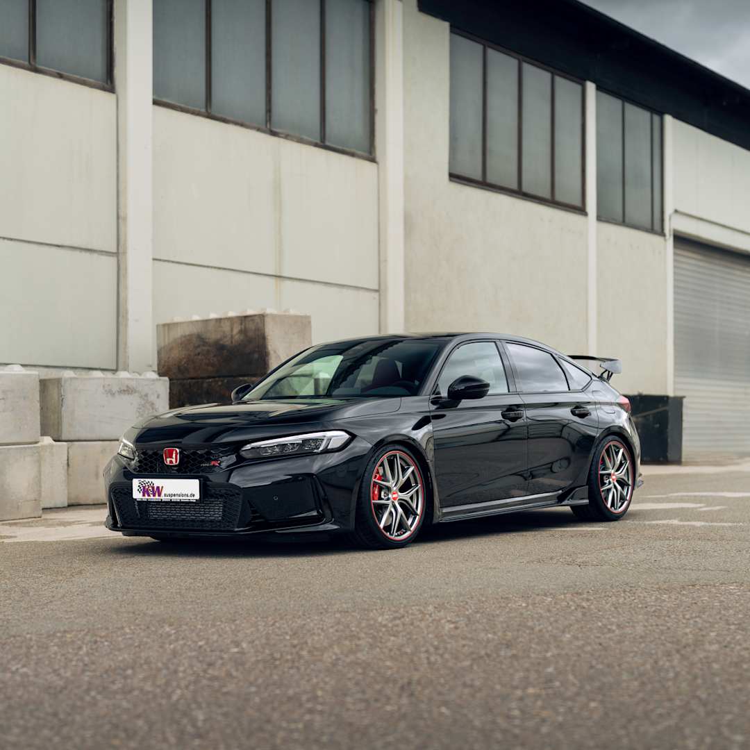 Black Honda Civic Type R (FE) parking in front of industrial building
