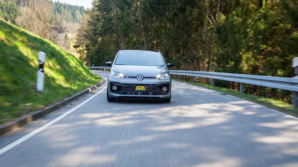 VW up! GTI with coilovers by ST suspensions while cornering on a country road