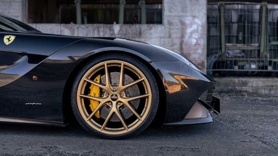 Black Ferrari F12 with continuously adjustable suspension lowering thanks to KW V5 and gold BBS wheels
