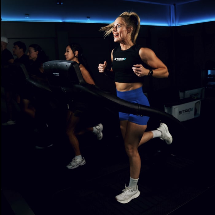 A member running on a treadmill during a STRIDE Fitness class