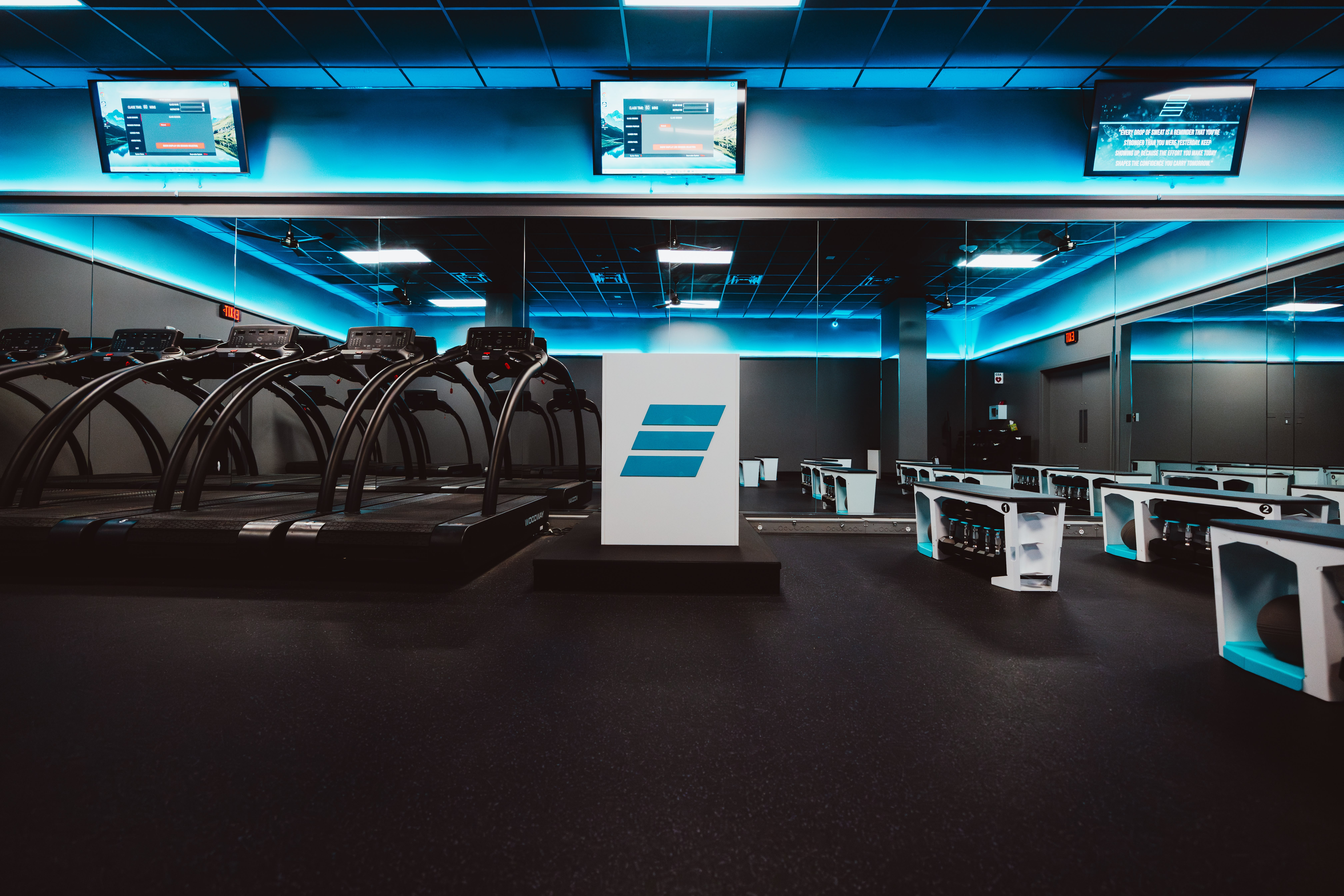 STRIDE Fitness Woodway treadmills lined up in studio