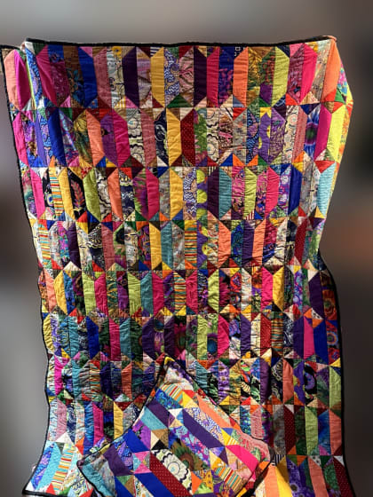 Bright patchwork quilt with matching pillow by Rose Tepp