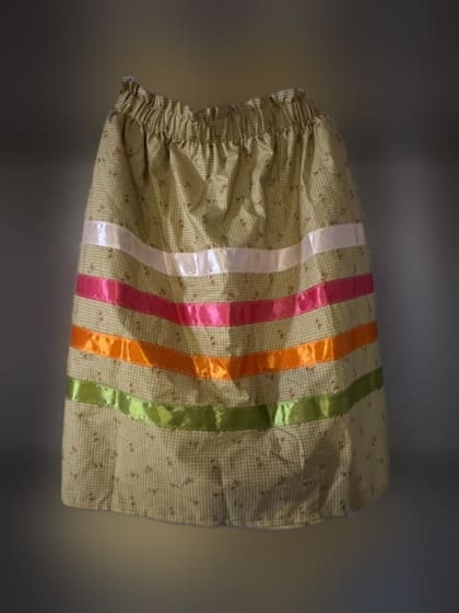 Green ribbon skirt with white, pink, orange and green ribbons, made by Haskell LIGHT students