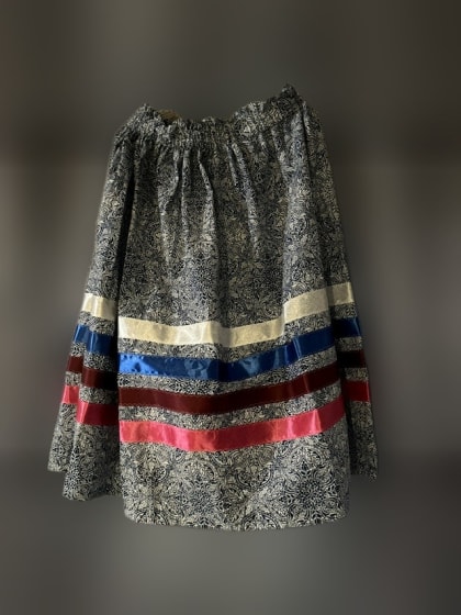Blue patterned ribbon skirt with cream, blue, maroon and pink ribbons, made by Haskell LIGHT students