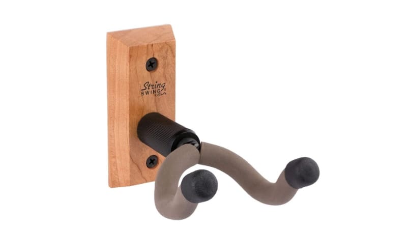 A wooden guitar wall hanger with a molded cradle