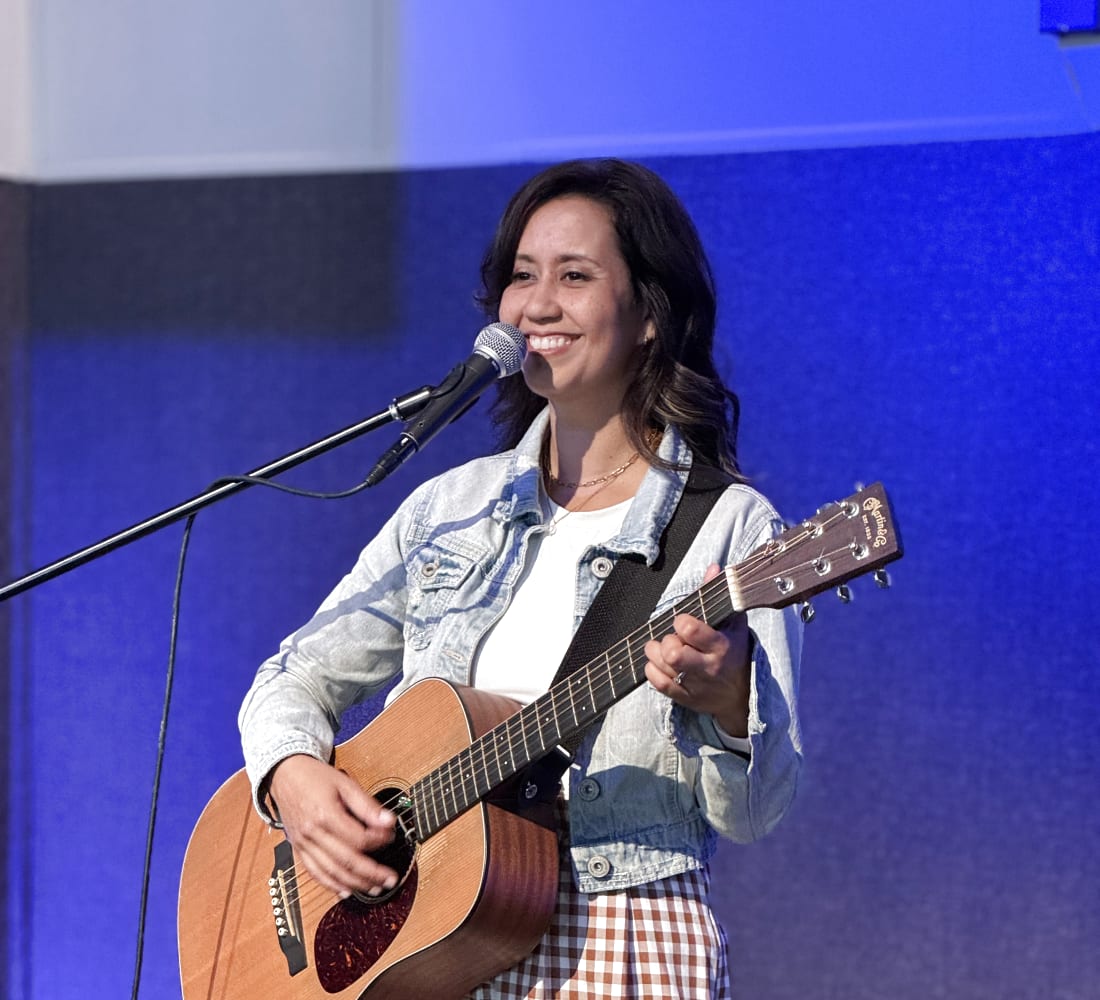 Becky Key playing guitar and singing