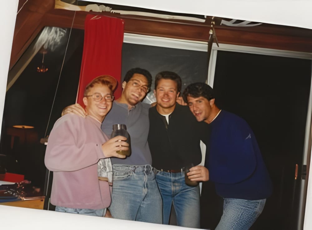 Four Delta Sig brothers, arms around each other, in the early days