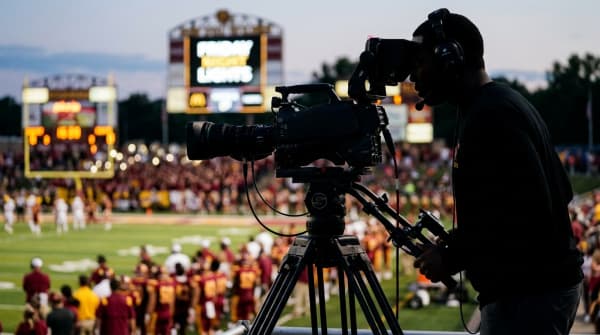 A broadcast camera filming a Friday-night Batavia Bulldogs football game