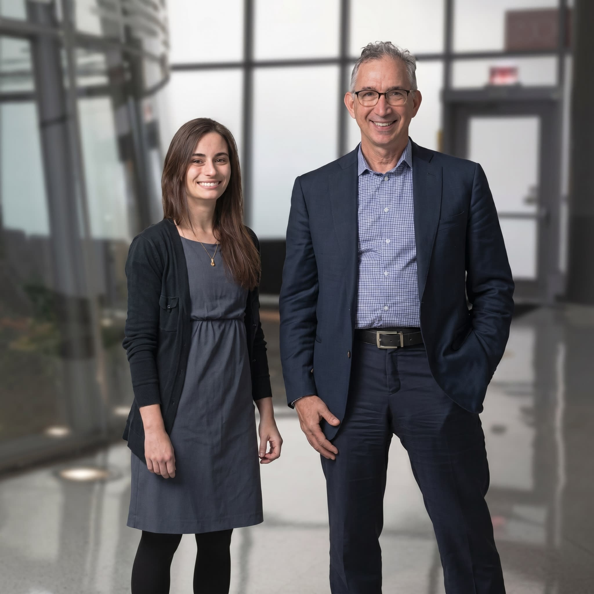 Dr. Kristen Pallok standing with Dr. David Ansell in a glass-walled lobby at Rush University Medical Center