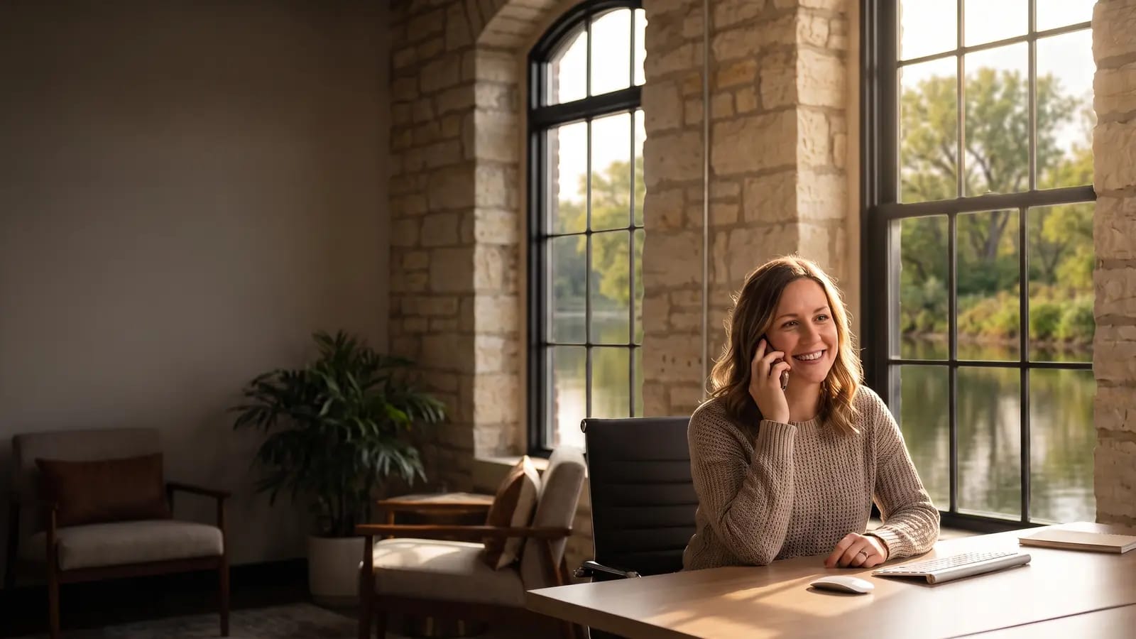 A Midwest Waste team member on the phone in the historic Challenge Windmill offices overlooking the Fox River