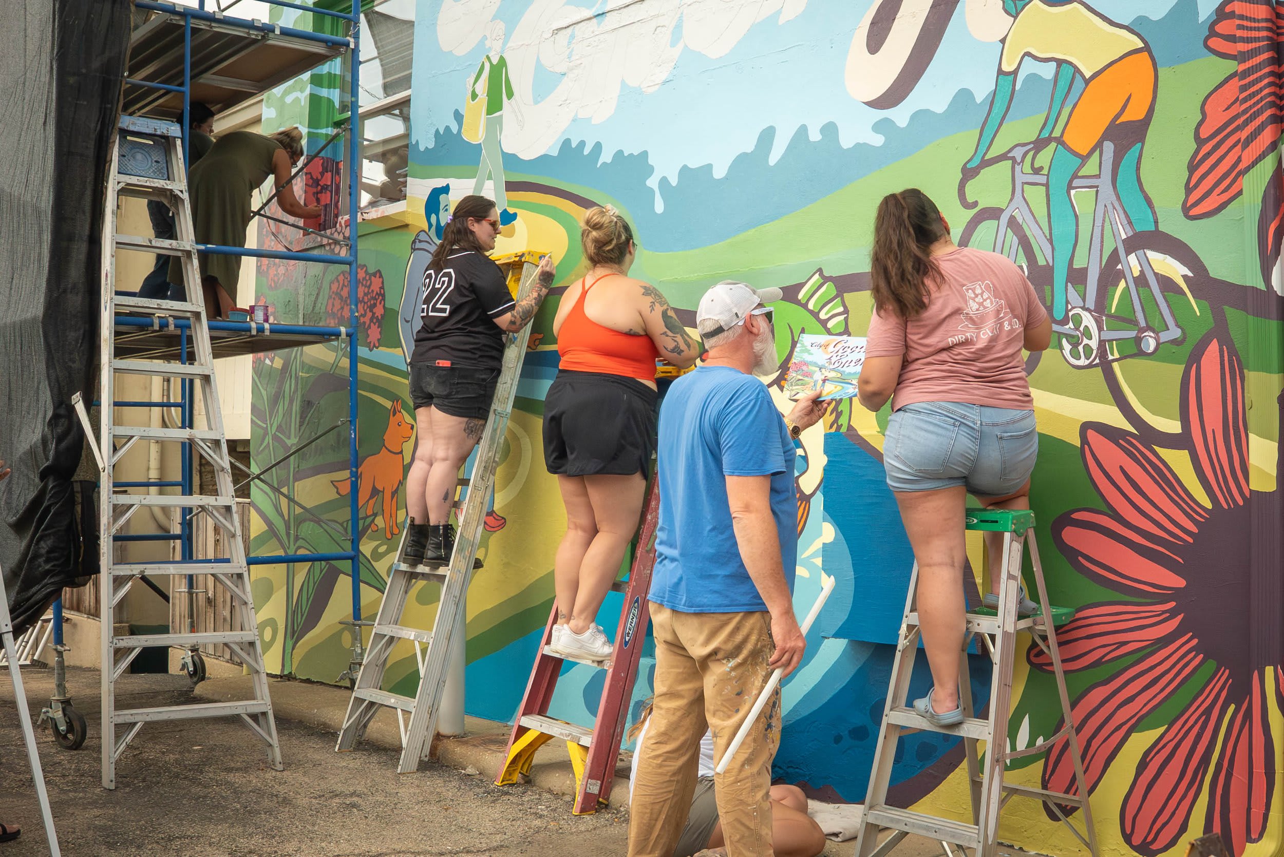Community volunteers painting a mural in Batavia
