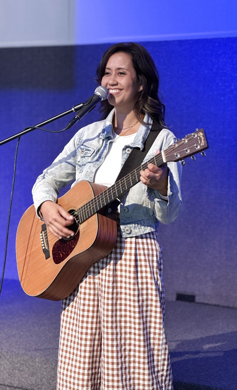 Becky Key playing guitar and singing