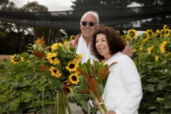 A visitor posing among the sunflowers in the Mornington Green garden.