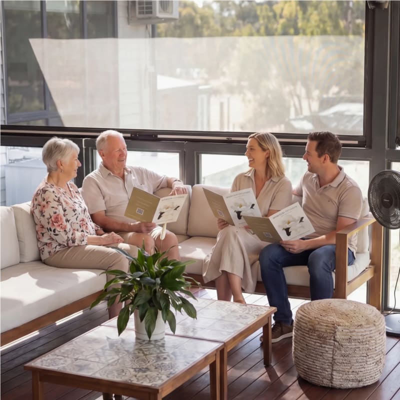 A family sitting together reviewing Mornington Green brochures with a Legacy Planner.