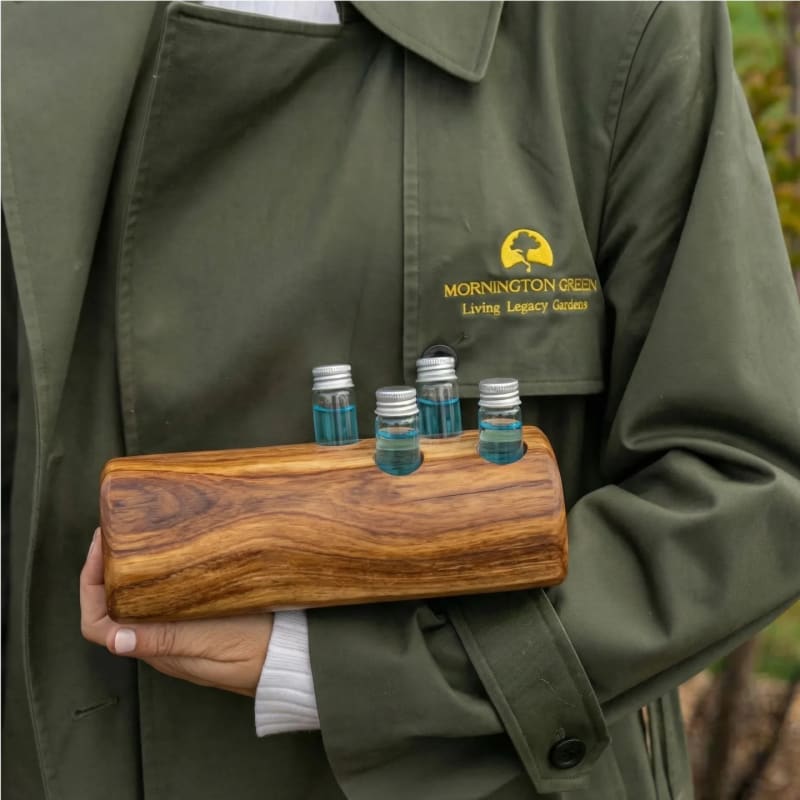 A Mornington Green team member holding vials of the blue Living Legacy Formula.