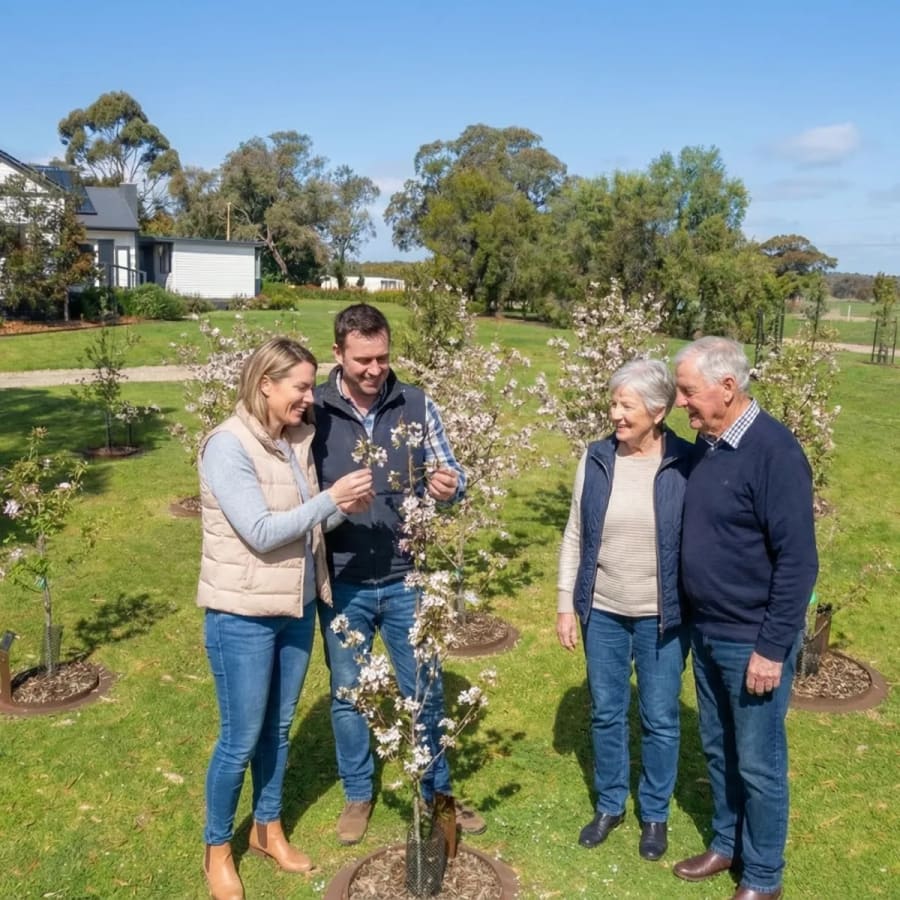 A family gathered among flowering memorial trees in the protected Mornington Green gardens.