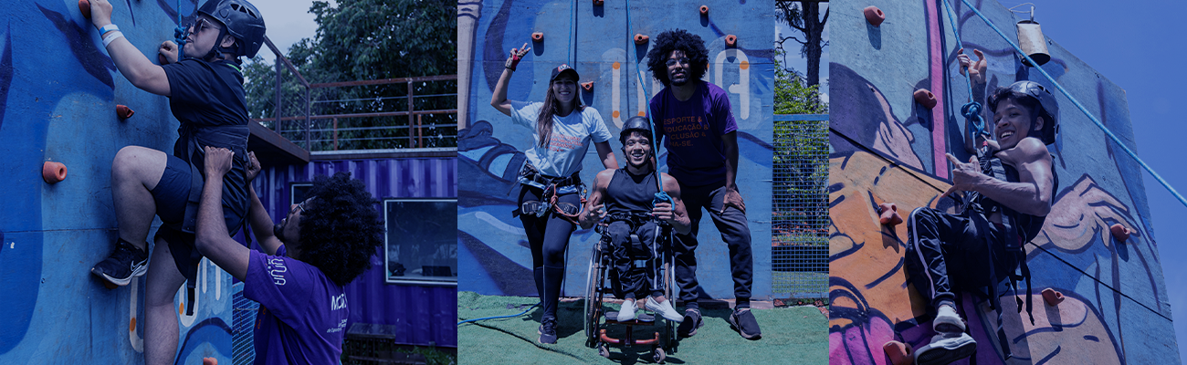 Pessoa em cadeira escaladora subindo parede de escalada inclusiva no UNA Parque