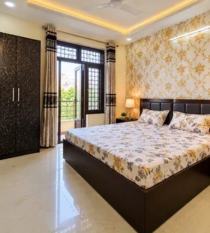 Modern Bedroom with Floral Bed and Balcony View.png