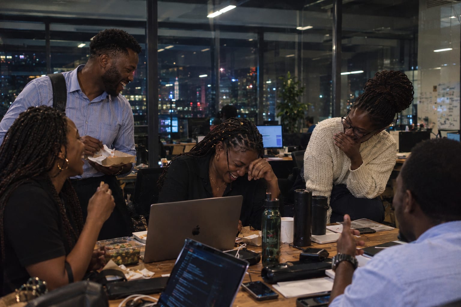 Joyful team gathered in the office full of energy and connection