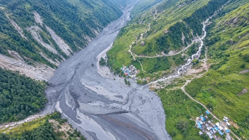 Raging muddy waters of swollen rivers in Nepal damaging roads bridges and washing away houses in flash floods