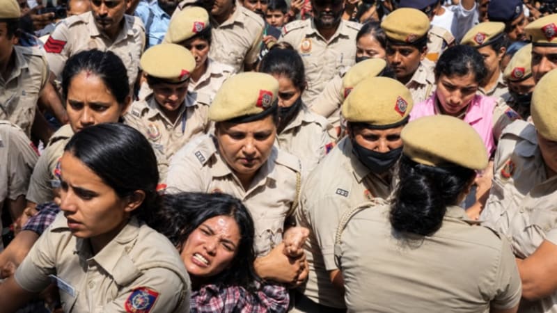 Protesters holding tricolor and posters during demonstrations in Delhi and Mumbai demanding resignation of CEC Gyanesh Kumar