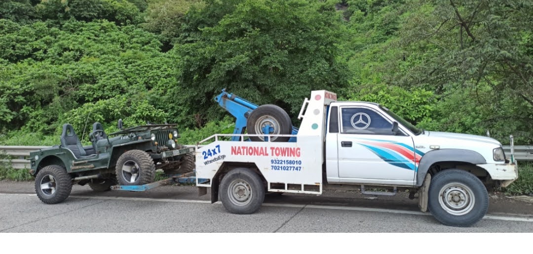 Car being towed after breakdown on roadside