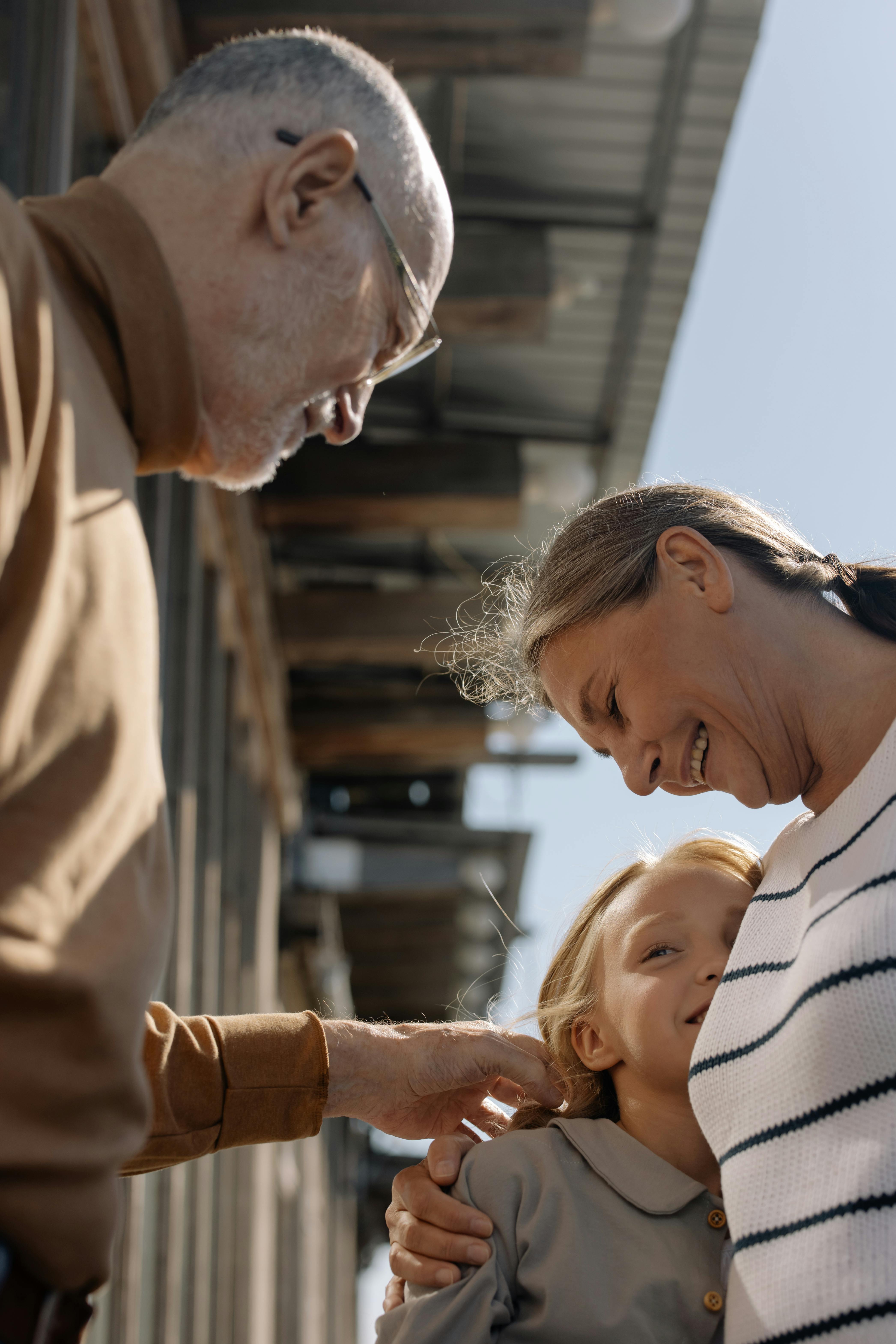 A happy family in front of their home, symbolizing security and legacy.