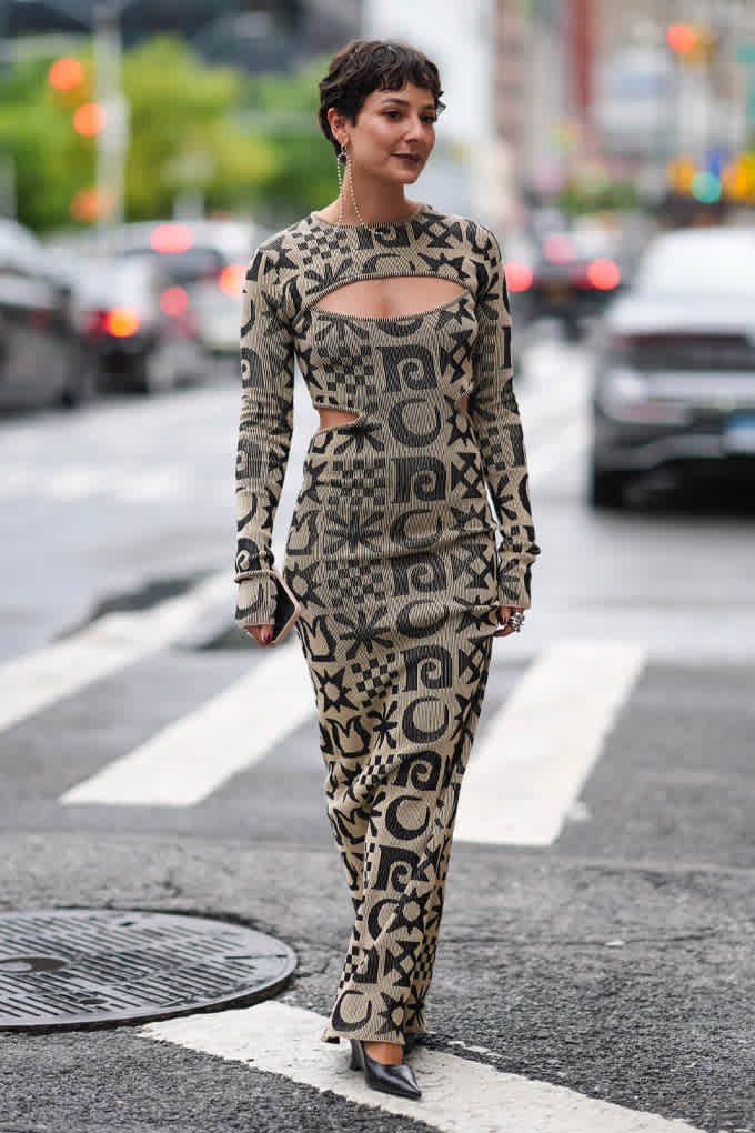 Frau in gemustertem Strick-Kleid mit Cut-Outs