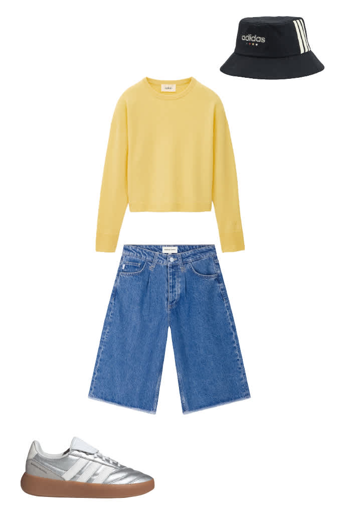 Lockeres WM-Outfit mit Bucket Hat, gelbem Sweater und Denim-Pants