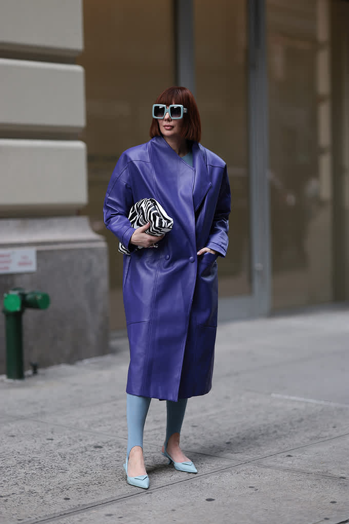 Frau trägt edgy Sonnenbrille, kombiniert mit lila Jacket und Zebra-Handbag
