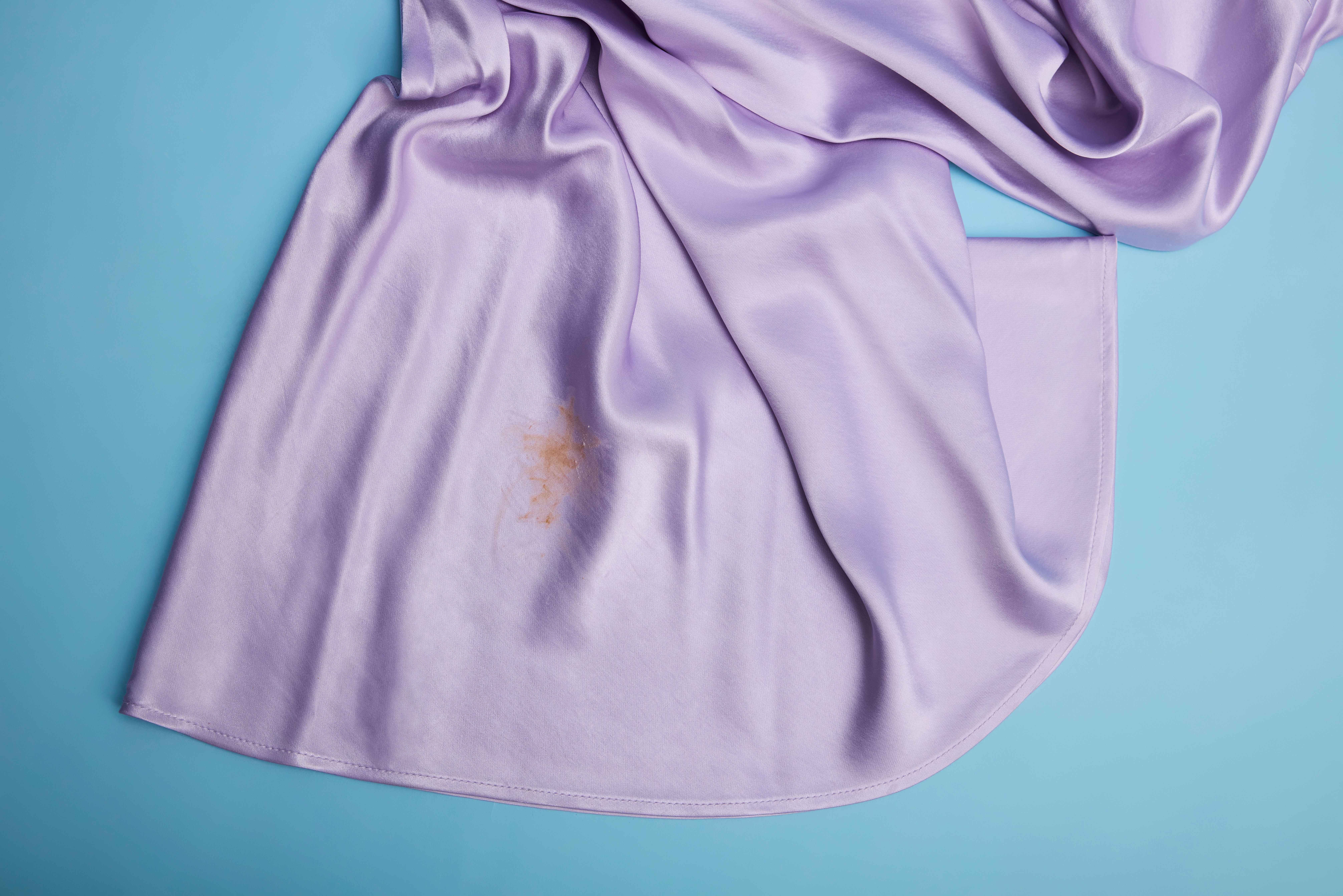 Lilafarbene Seidenbluse mit braunem Fleck