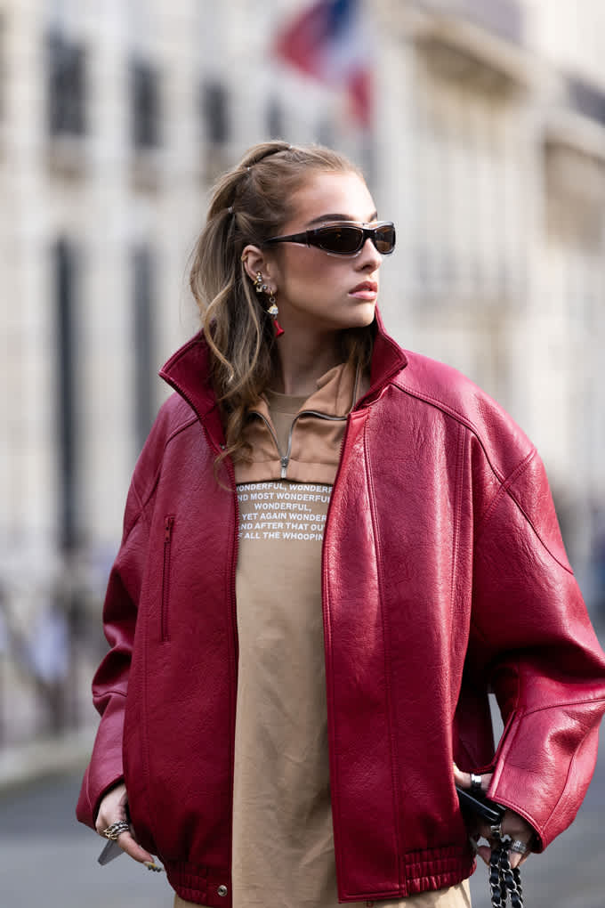 Frau mit Sonnenbrille trägt roten Leder-Blouson