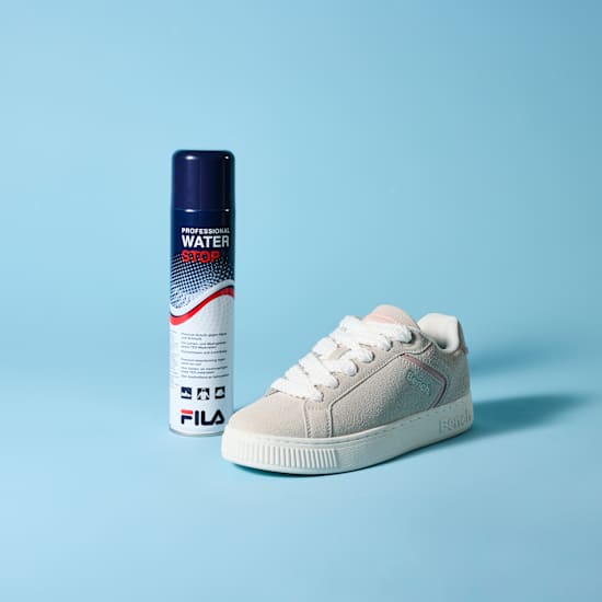 Dose Imprägnierspray steht neben weißem Sneaker-Schuh