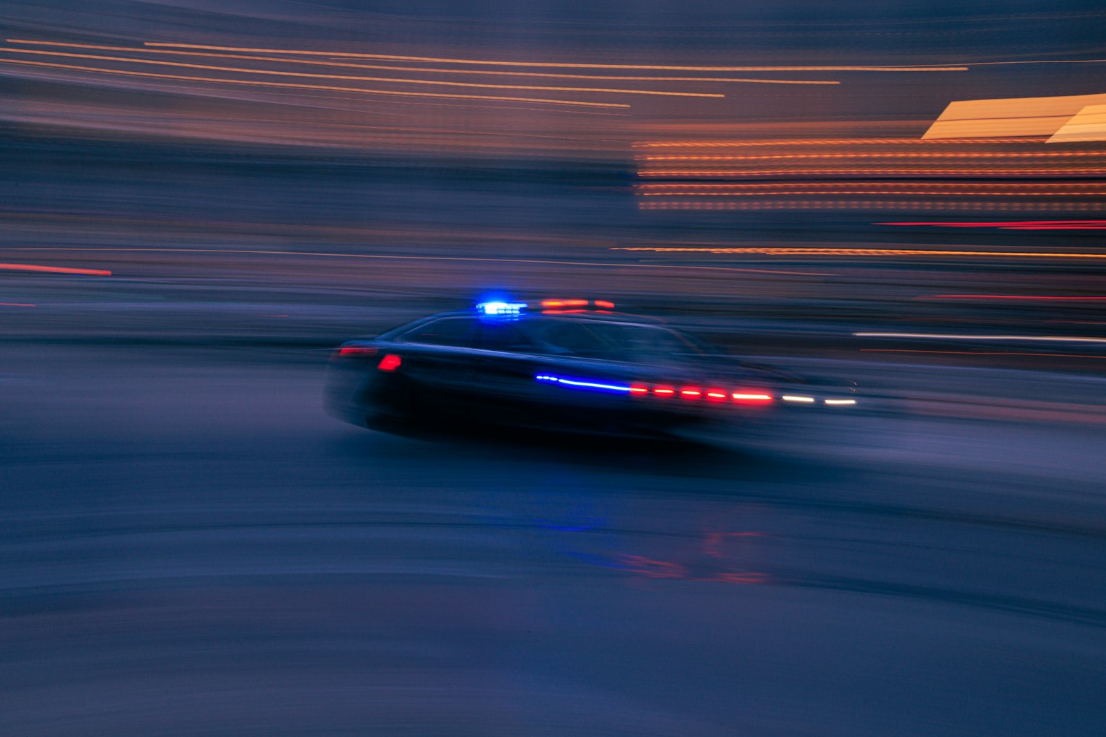 Police car at night on city street