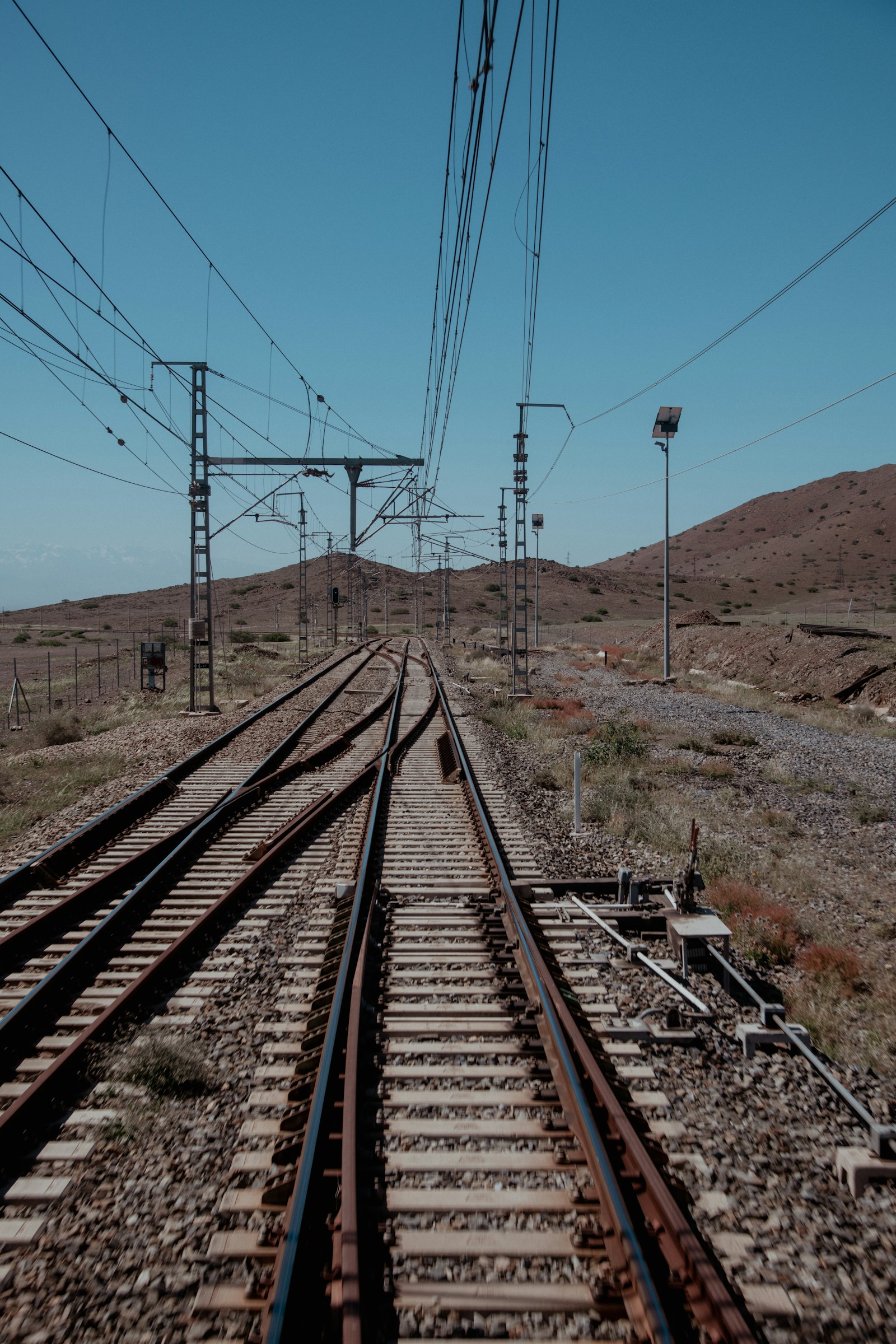 Train track running through desert landscape