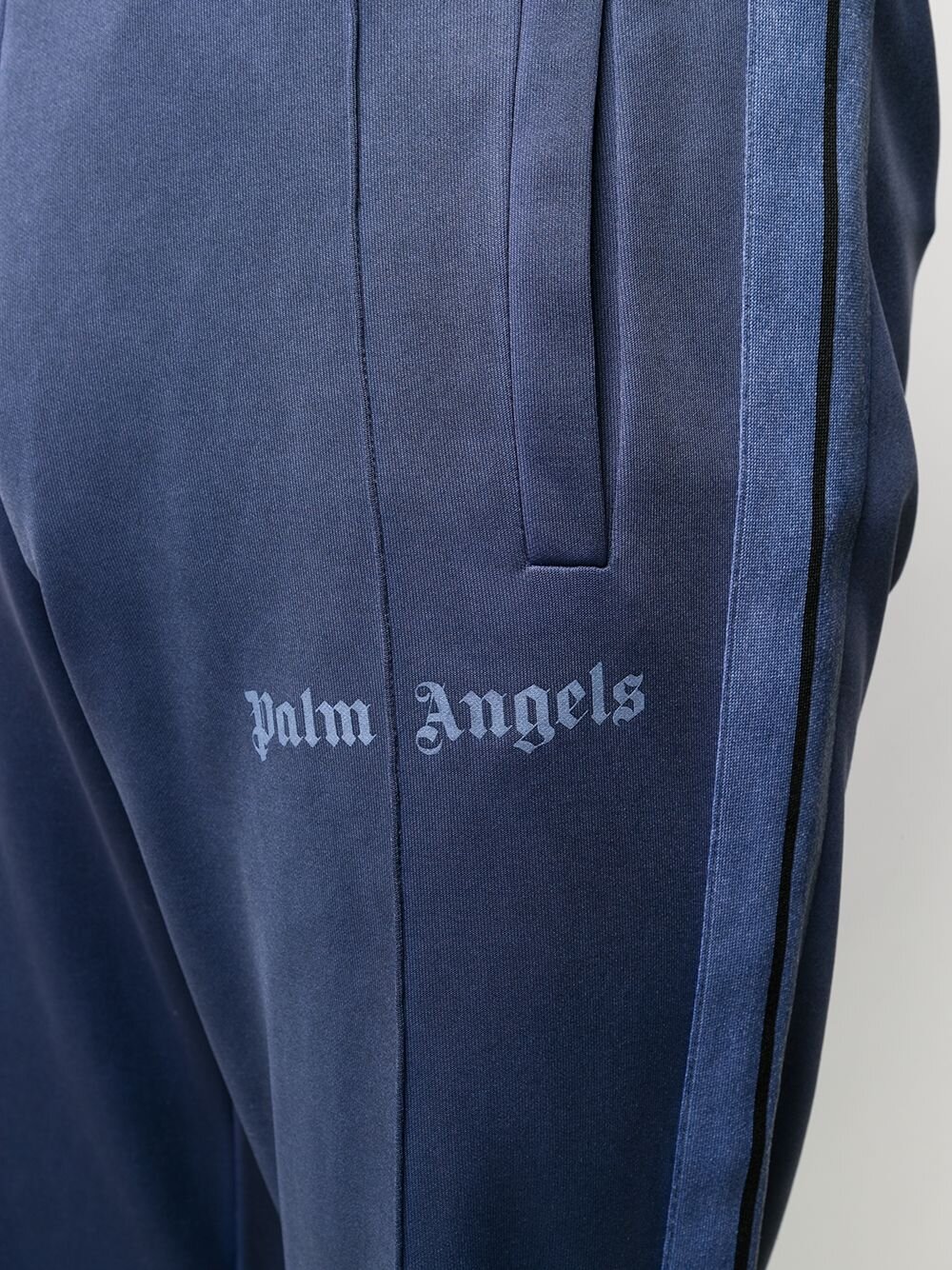 PALM ANGELS LOGO PRINT TRACK PANTS. Vertical stripes