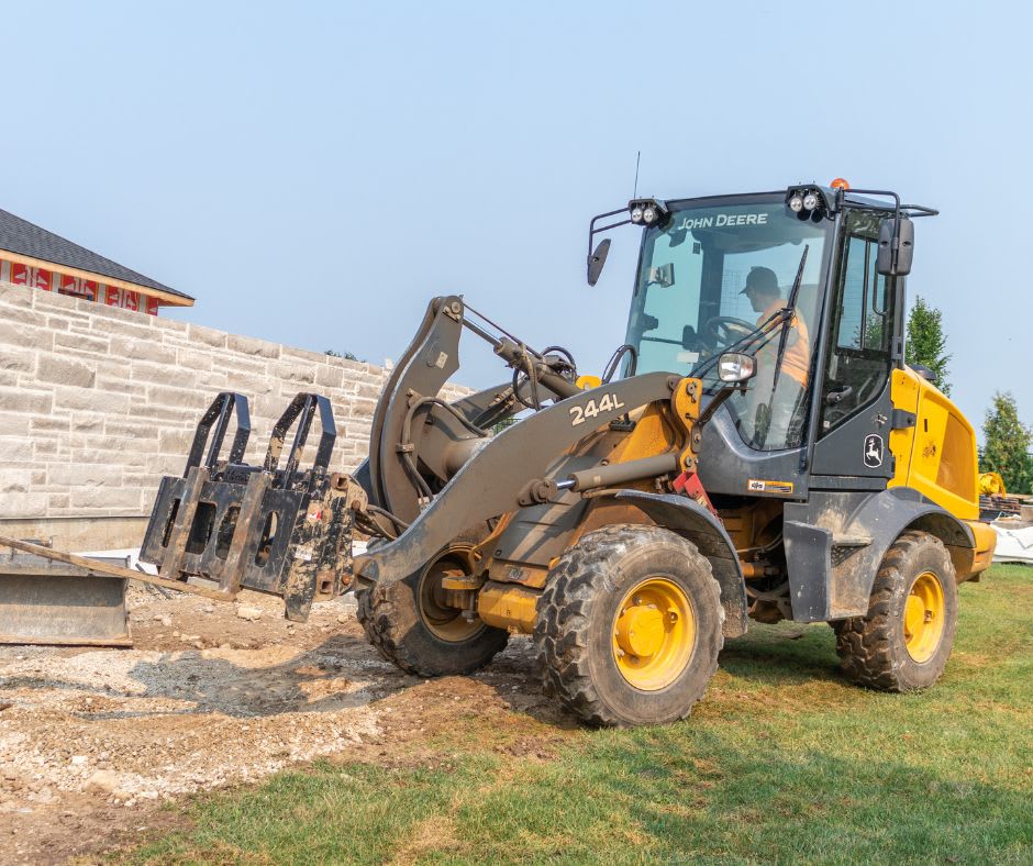 John Deere 244L wheel loader with forks