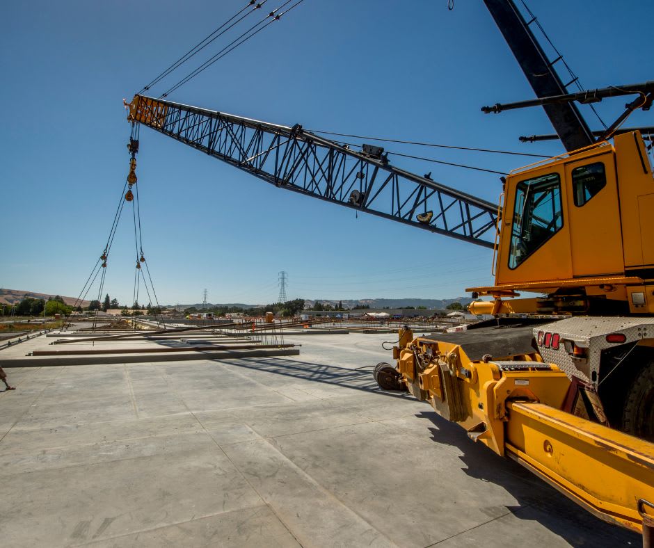 Using a crane to host and place the concrete walls